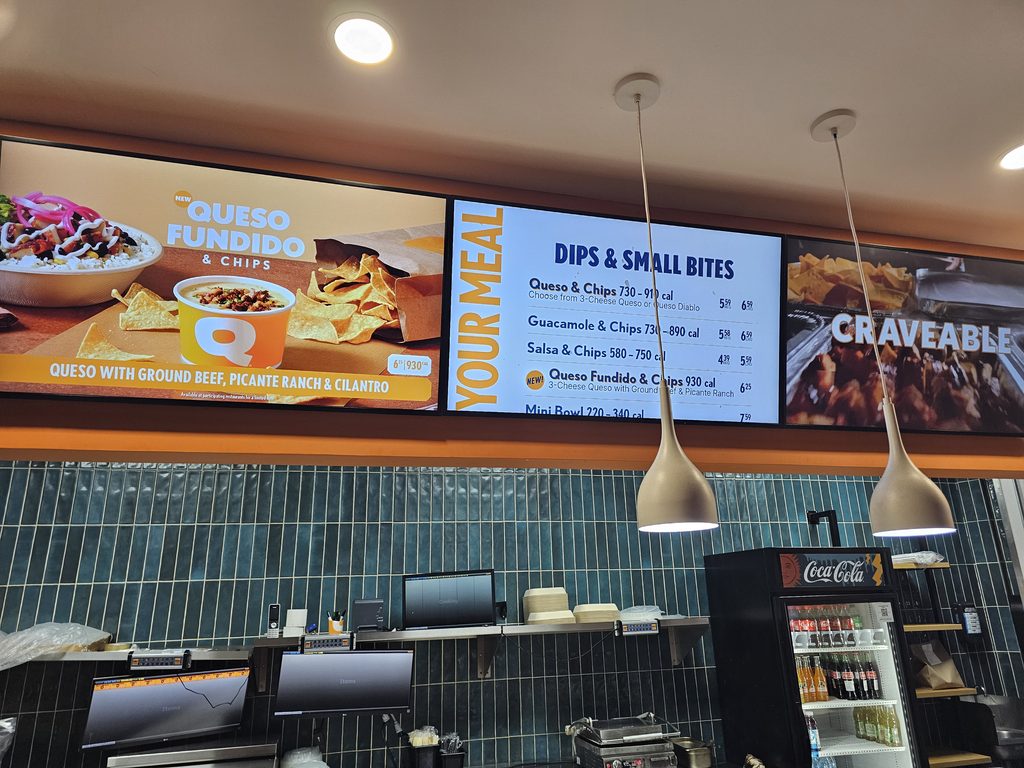 Menu boards with dips, small bites, and queso fundido at QDOBA Fordham Road