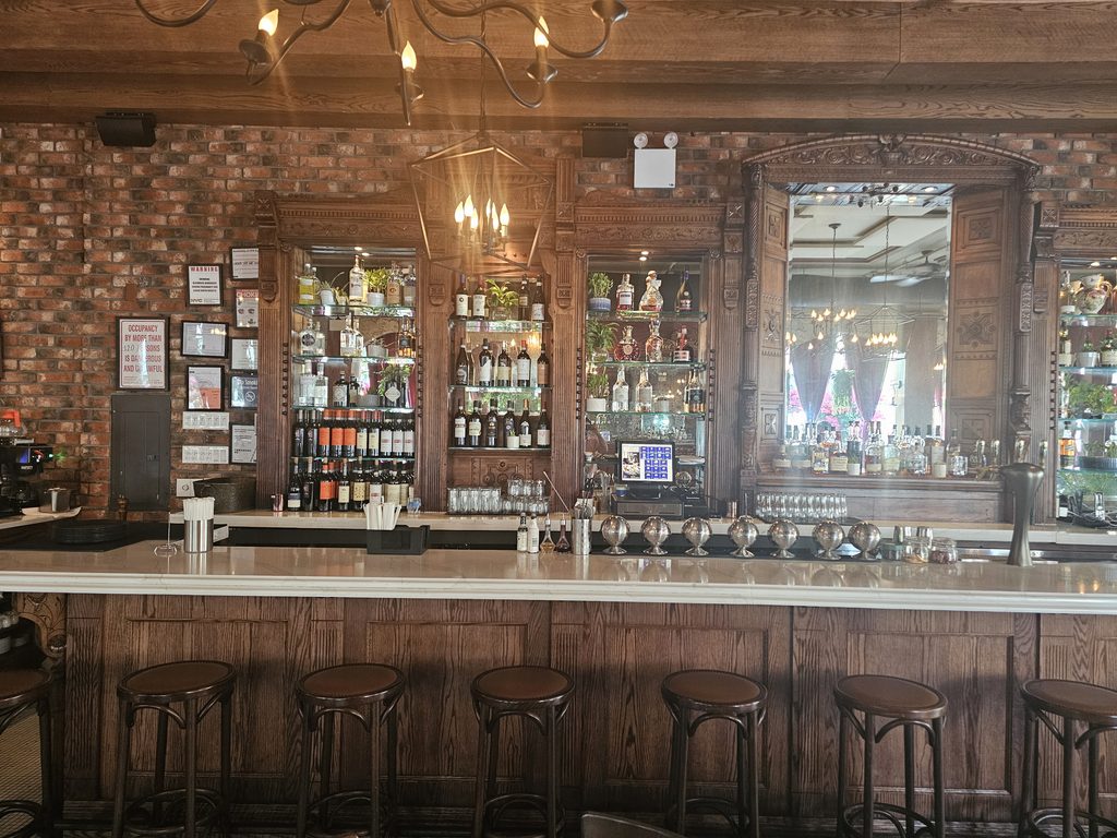 The bar and bottle display add a classic Italian restaurant feel.