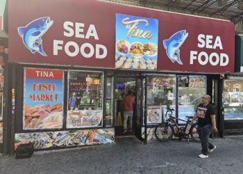 : El Tina Fish Market NYC storefront and seafood market sign on West 207th Street