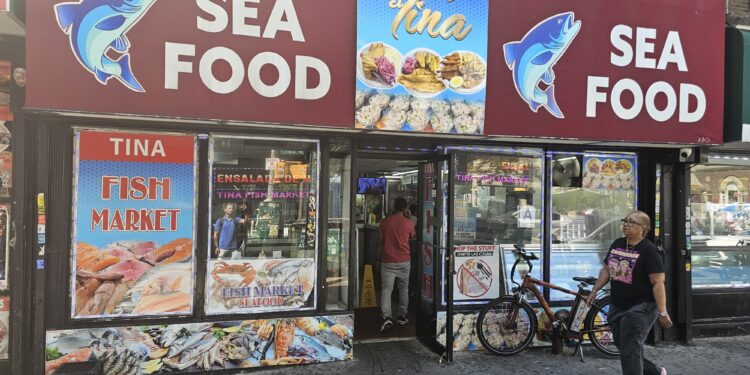 : El Tina Fish Market NYC storefront and seafood market sign on West 207th Street