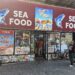 : El Tina Fish Market NYC storefront and seafood market sign on West 207th Street