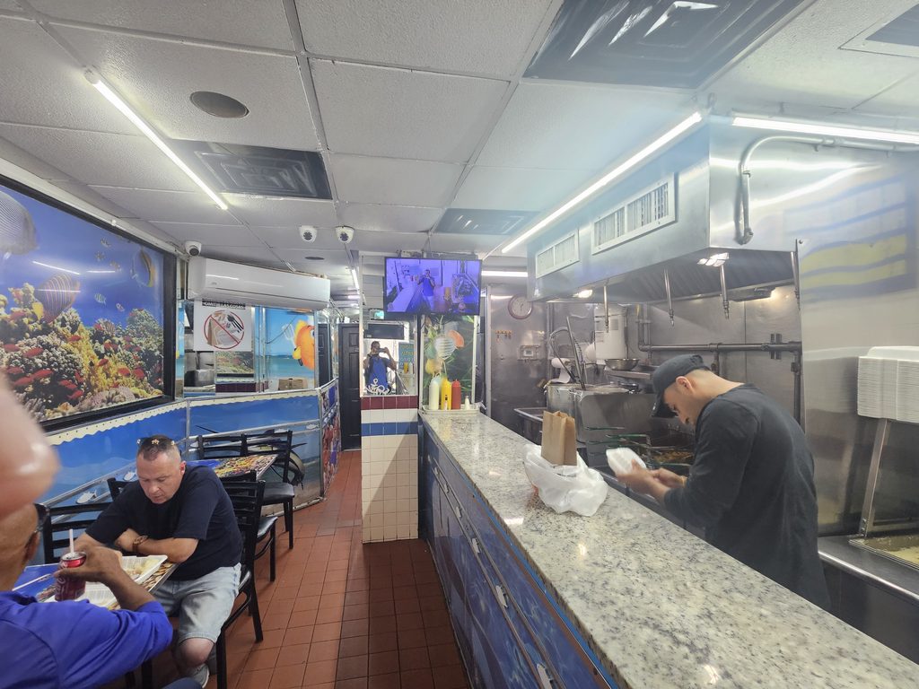 Inside the seafood counter, orders are prepared for quick pickup.