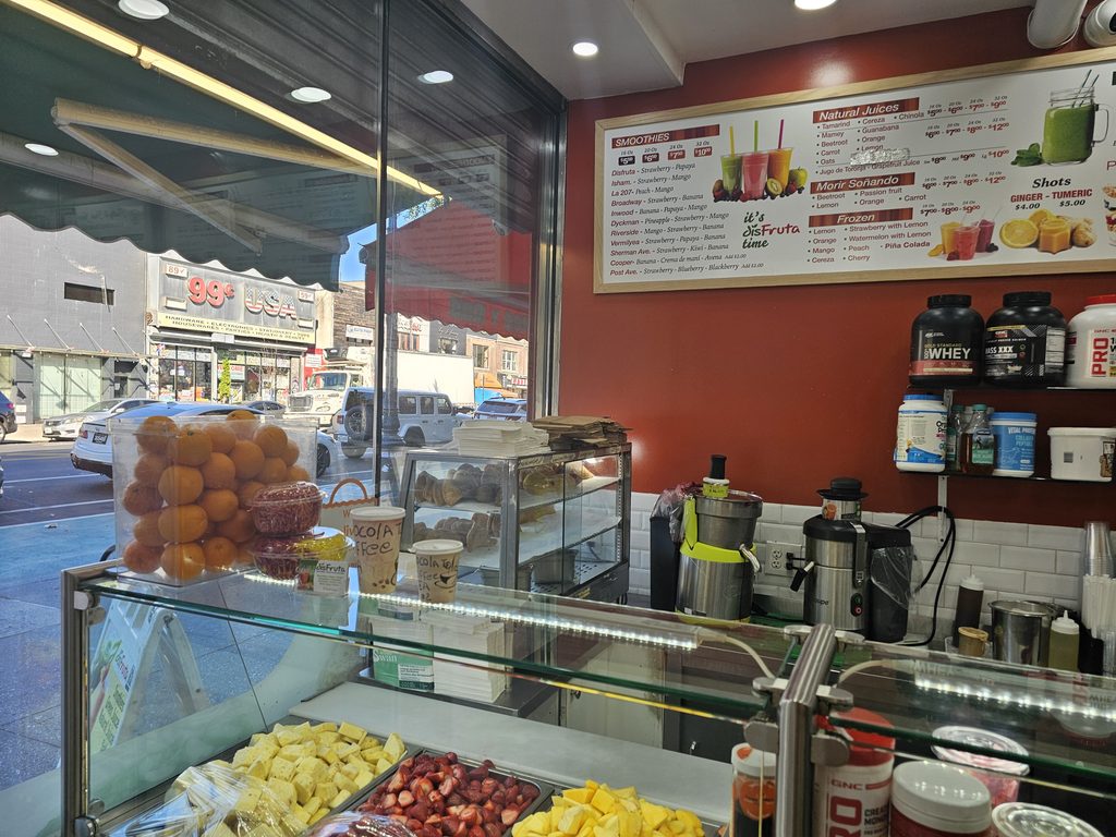 DisFruta Juice Bar NYC counter with fresh ingredients and menu boards