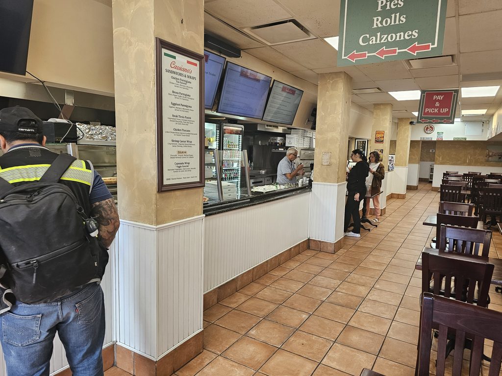 Dining counter and seating area inside Cassiano’s Pizza NYC