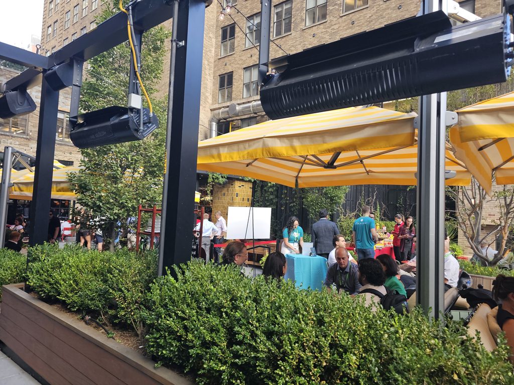  Bar Primi Penn District entrance framed by greenery and outdoor seating