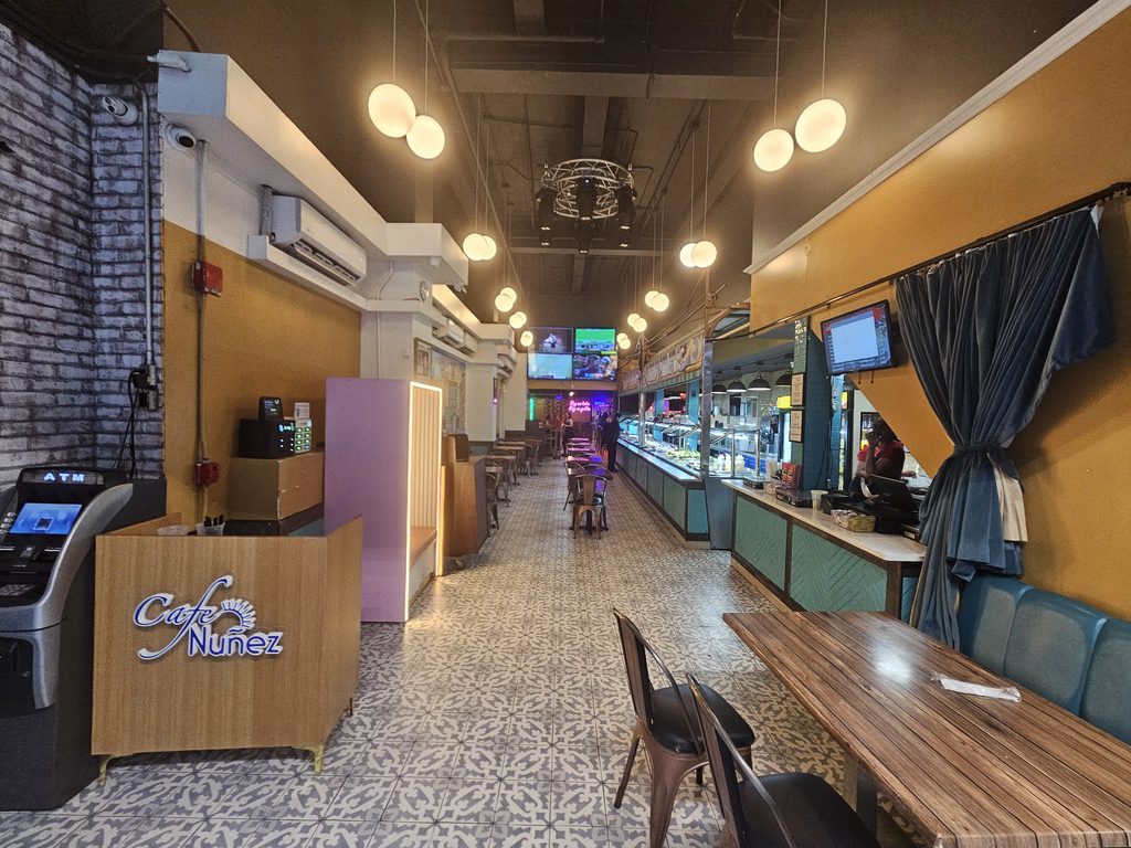 Café Nuñez NYC dining room with wood tables, warm lighting, and buffet area