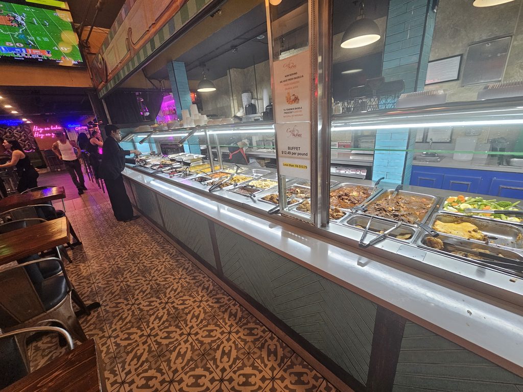 Café Nuñez NYC buffet counter with hot food selections and dining area