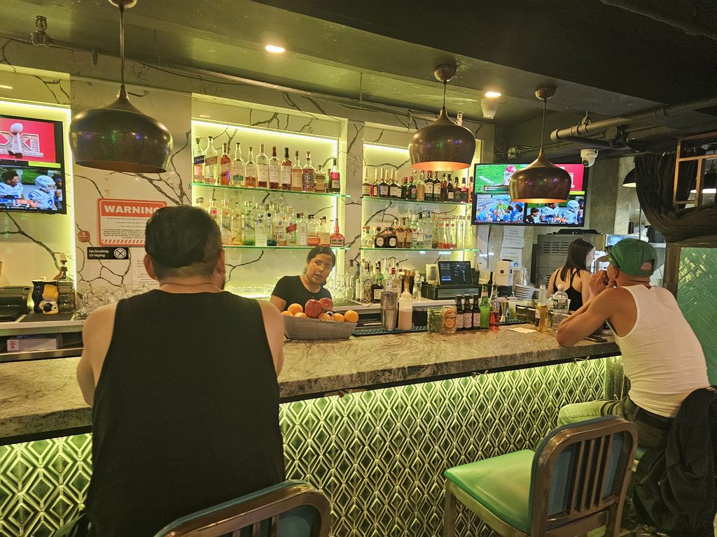 Café Nuñez NYC bar and lounge area with guests and colorful lighting