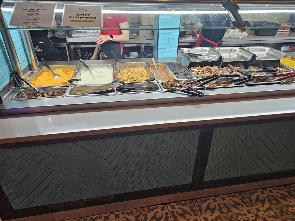 Café Nuñez NYC buffet service counter with rice, sides, and hot food selections