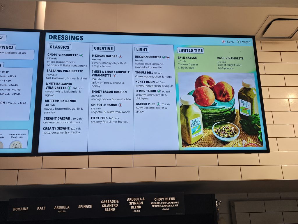 Dressing menu board with classic, creative, and light options at Chopt Midtown Manhattan