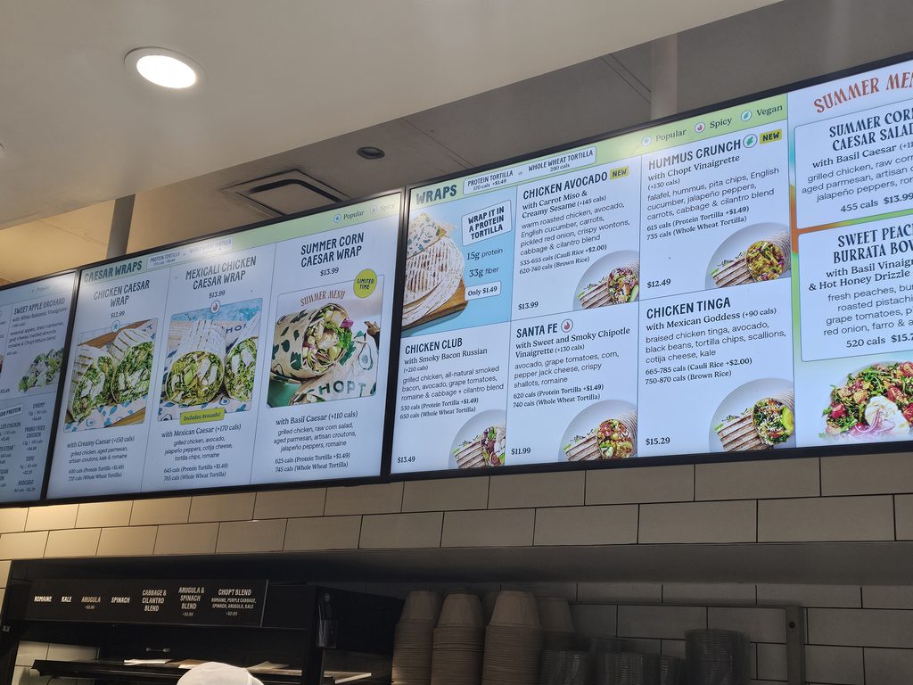 Wraps and Caesar wraps menu screens at Chopt Midtown Manhattan