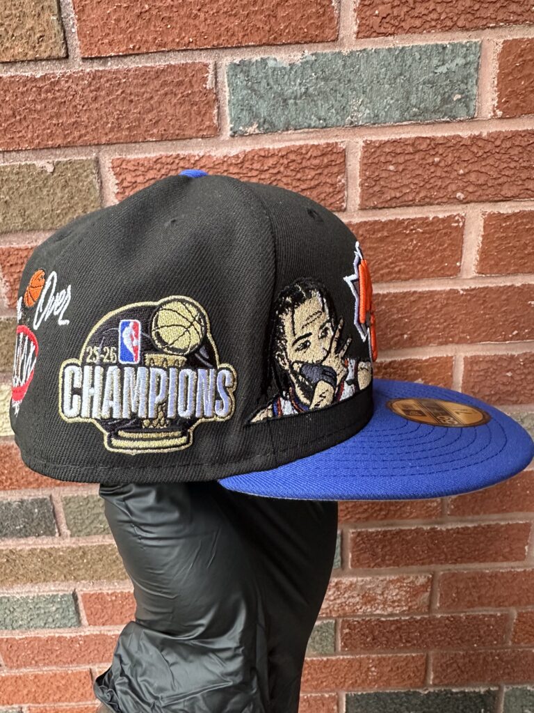 Alt text: The Vintage NYC fitted hat with detailed New York sports embroidery and blue brim